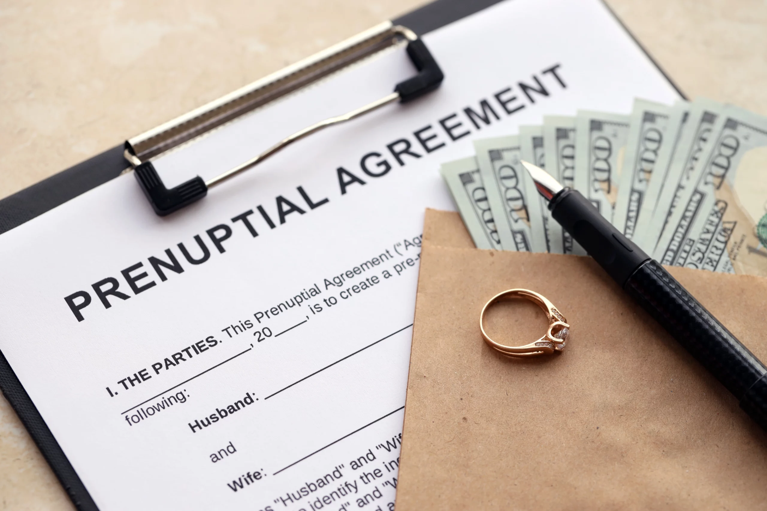 Prenuptial agreement with money, ring, and pen highlights marital planning in Florida.